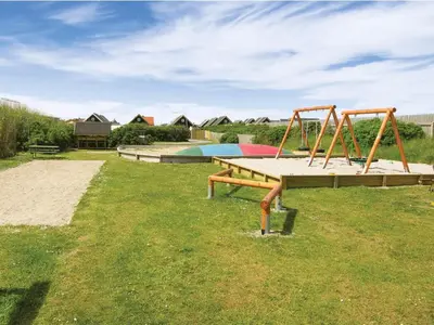 a park with two swings and a playground at 4 star holiday home in Thyborøn in Thyborøn