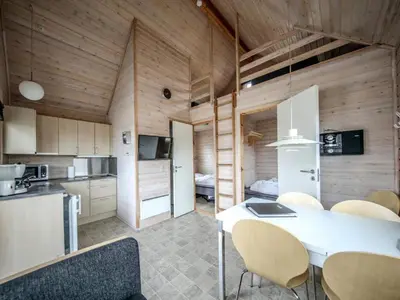 a kitchen and dining room with a table and chairs at 4 star holiday home in Thyborøn in Thyborøn