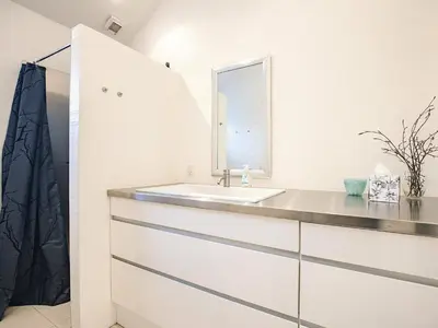 a bathroom with a sink and a mirror at 4 star holiday home in Blokhus in Blokhus