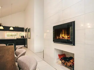 a fireplace in a living room with a fire place at 4 star holiday home in Blokhus in Blokhus