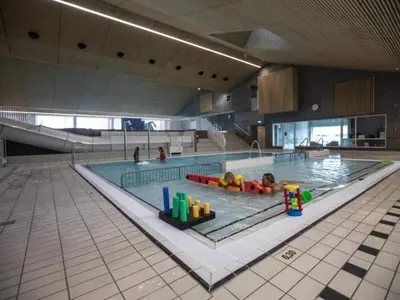 a large swimming pool with two children in it at 4 star holiday home in Thyborøn in Thyborøn