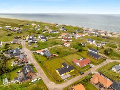 an aerial view of a small village by the ocean at Lovely Holiday Home With Fenced Plot, 300 Meters From The North Sea In Thy in Lild Strand