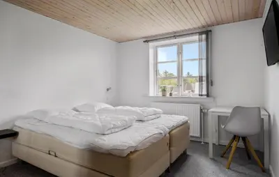 a white bedroom with a bed and a window at Stunning Home In Blokhus With Wifi in Blokhus