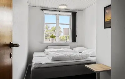 a bed in a room with a window at Stunning Home In Blokhus With Wifi in Blokhus