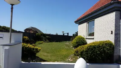 a backyard of a house with a yard at Bed & Breakfast i Vorupør in Nørre Vorupør