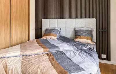 a bedroom with a large bed with two pillows at Cozy Apartment In Blokhus With Wifi in Blokhus