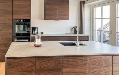 a kitchen with wooden cabinets and a counter top at Cozy Apartment In Blokhus With Wifi in Blokhus