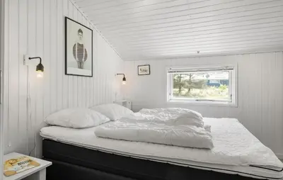 a bed in a white room with a window at 3 Bedroom Nice Home In Fjerritslev in Fjerritslev