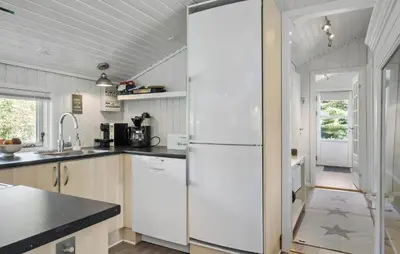 a kitchen with a white refrigerator and a sink at 3 Bedroom Nice Home In Fjerritslev in Fjerritslev