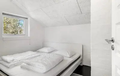 a white bed in a room with a window at Amazing Home In Thisted With Sauna in Thisted