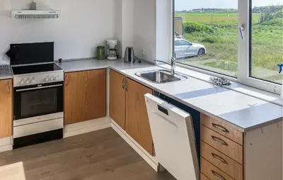 a kitchen with a sink and a stove and a window at Amazing Home In Harboøre With Wifi in Harboør