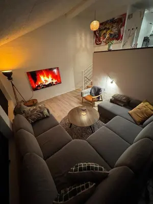 a living room with a couch and a fireplace at Villa Centrum in Holstebro