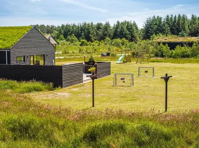 a yard with two goal posts in the grass at Laustvej 3 in Saltum