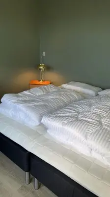 a large white bed sitting in a room at VillaRanum in Ranum