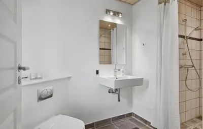 a white bathroom with a sink and a toilet at Amazing Home In Spøttrup in Spottrup
