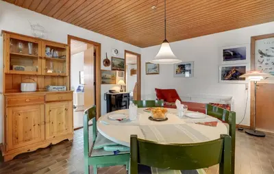 a kitchen and dining room with a table and chairs at 2 Bedroom Pet Friendly Home In Thisted in Thisted