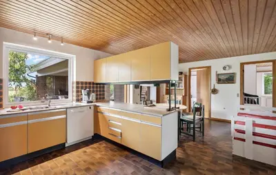a kitchen with white cabinets and a wooden ceiling at 2 Bedroom Pet Friendly Home In Thisted in Thisted