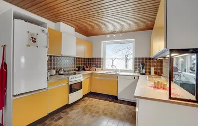 a kitchen with yellow and white cabinets and a window at 2 Bedroom Pet Friendly Home In Thisted in Thisted
