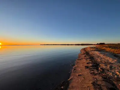 a view of a body of water with the sun setting at 6 person holiday home in Thyholm in Thyholm