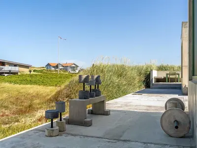 a group of sculptures sitting on the side of a building at Holiday Home Rieke - 250m from the sea by Interhome in Torsted