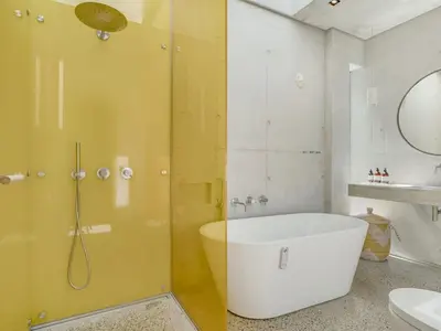 a bathroom with a tub and a shower and a sink at Holiday Home Rieke - 250m from the sea by Interhome in Torsted