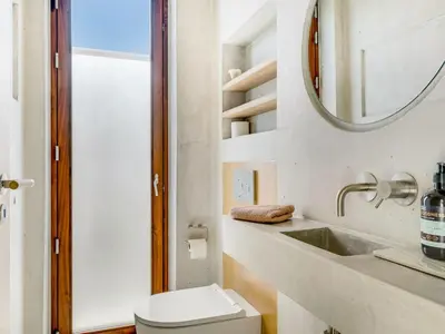 a bathroom with a toilet and a sink and a mirror at Holiday Home Rieke - 250m from the sea by Interhome in Torsted