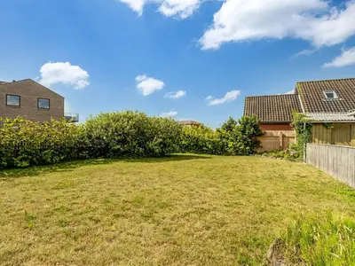 a yard with a fence and a house at Holiday Home Antine - 400m from the sea by Interhome in Thyborøn