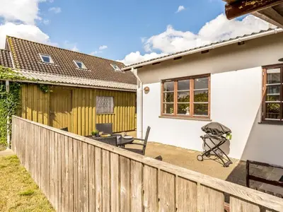 a view of the back yard of a house with a fence at Holiday Home Antine - 400m from the sea by Interhome in Thyborøn