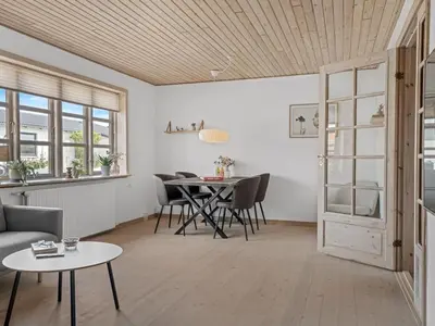 a living room with a table and chairs at Holiday Home Antine - 400m from the sea by Interhome in Thyborøn