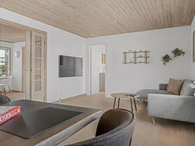 a living room with a couch and a table at Holiday Home Antine - 400m from the sea by Interhome in Thyborøn