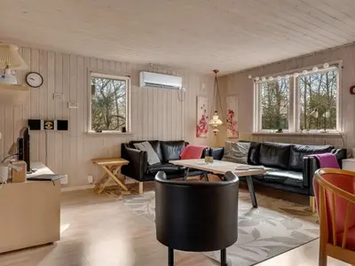 a living room with a couch and a table at Holiday Home Iris - 200m to the fjord by Interhome in Thyholm