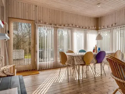 a dining room with a table and chairs at Holiday Home Iris - 200m to the fjord by Interhome in Thyholm