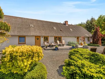 a house with a large yard with bushes at Holiday Home Elia - 5km to the fjord by Interhome in Spottrup