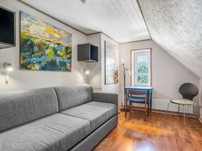 a living room with a couch and a table at Holiday Home Elia - 5km to the fjord by Interhome in Spottrup