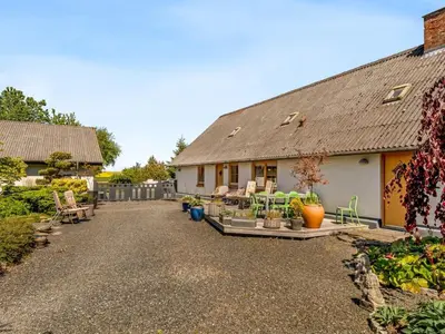 a house with a gravel driveway in front of it at Holiday Home Elia - 5km to the fjord by Interhome in Spottrup