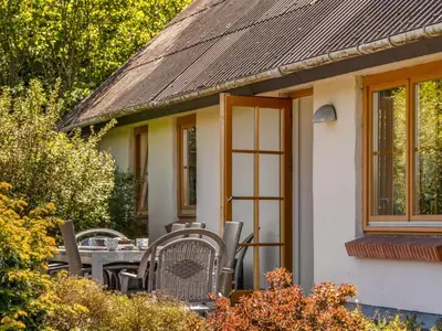 a table and chairs in front of a house at Holiday Home Elia - 5km to the fjord by Interhome in Spottrup