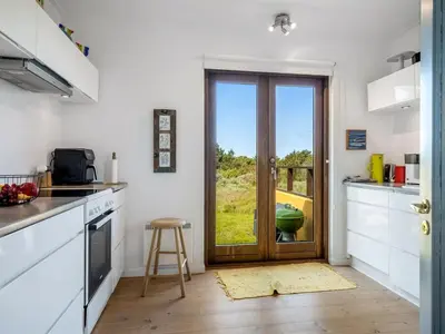 a kitchen with a door leading to a yard at Holiday Home Ola - 900m from the sea by Interhome in Bedsted Thy