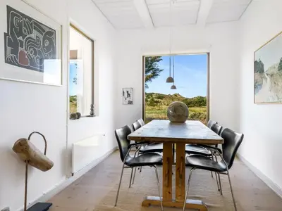 a dining room with a table and chairs at Holiday Home Ola - 900m from the sea by Interhome in Bedsted Thy
