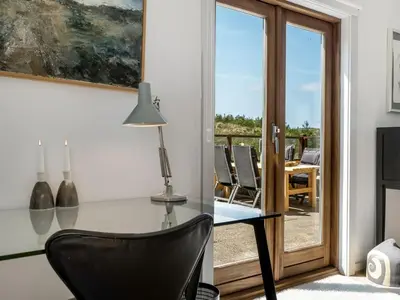 a dining room with a glass table and a chair at Holiday Home Ola - 900m from the sea by Interhome in Bedsted Thy