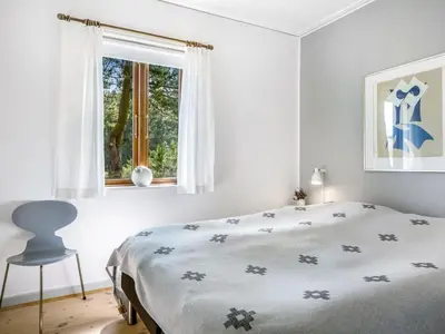 a white bedroom with a bed and a window at Holiday Home Ola - 900m from the sea by Interhome in Bedsted Thy