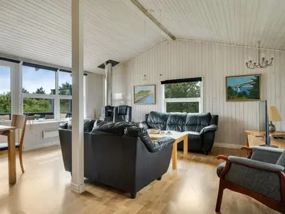 a living room with a couch and a table at Holiday Home Claudine - 700m from the sea by Interhome in Thisted
