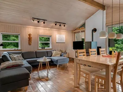 a living room with a couch and a table at Holiday Home Ginette - 400m to the fjord by Interhome in Åbybro