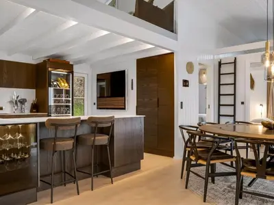 a kitchen with a wooden table and chairs at Holiday Home Marcus - 500m from the sea by Interhome in Saltum