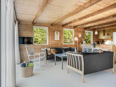 a living room with a couch and a table at Holiday Home Laris - 700m to the fjord by Interhome in Løgsted