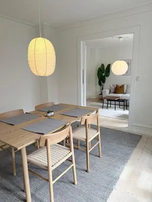 a dining room with a wooden table and chairs at Cozy pearl downtown Viborg in Viborg