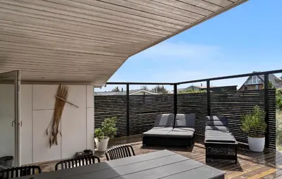 a patio with a table and chairs on a deck at Pet Friendly Home In Vestervig With Wifi in Vestervig