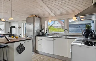 a kitchen with white cabinets and a large window at Pet Friendly Home In Vestervig With Wifi in Vestervig