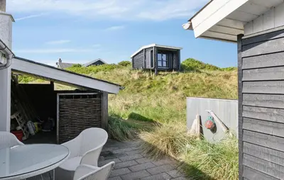 a house on the side of a hill with a building at Pet Friendly Home In Vestervig With Wifi in Vestervig