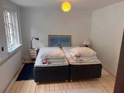 a bed sitting in a room with at Villa Bakkely in Lemvig