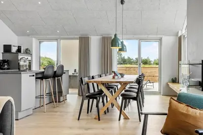 a kitchen and dining room with a wooden table and chairs at 871-Thisted-Smedevej-3-A in Thisted